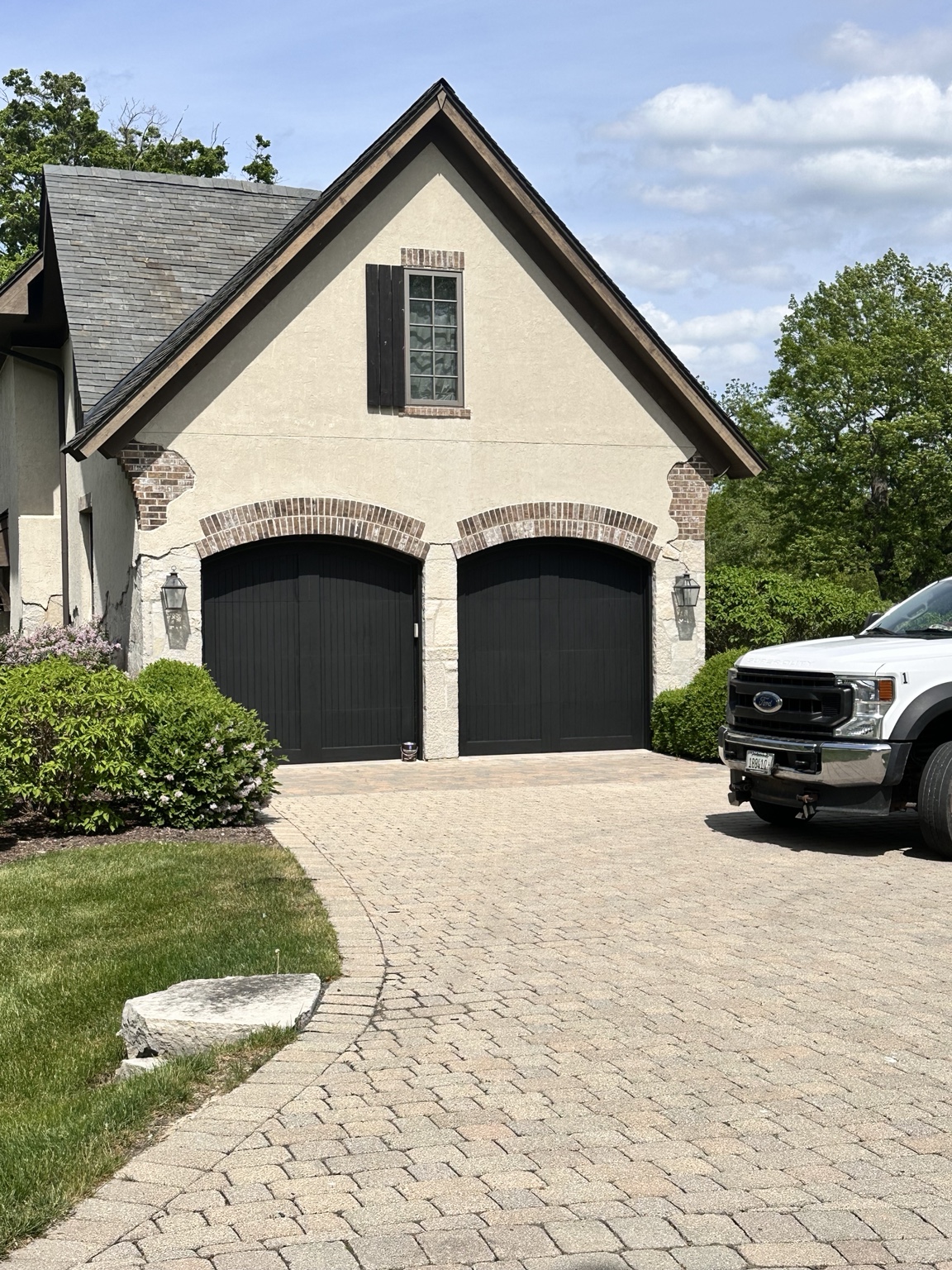 Home exterior with dark finished garage doors