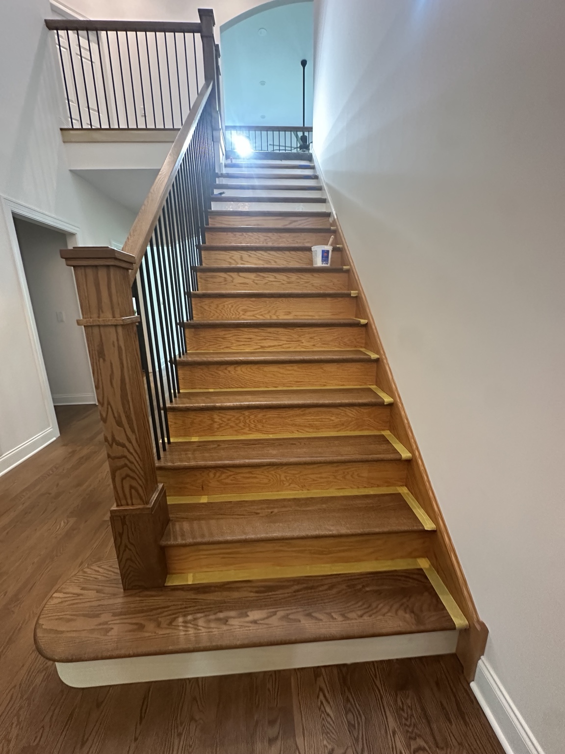 Wood staircase with masked edges during refinishing